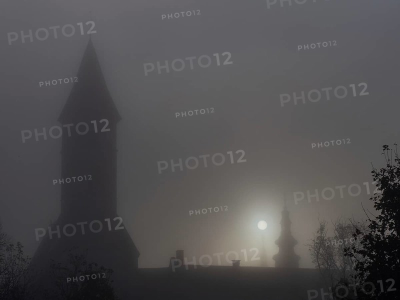 Church tower in the morning mist