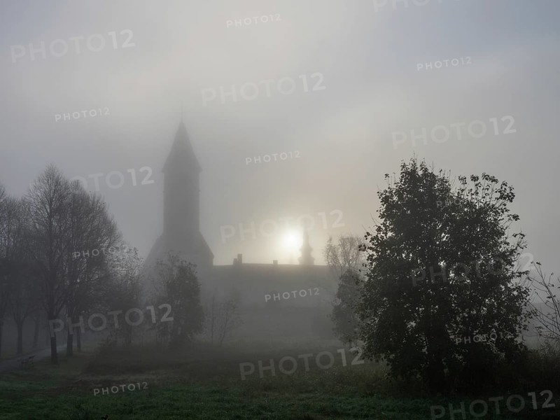 Church tower in the morning mist