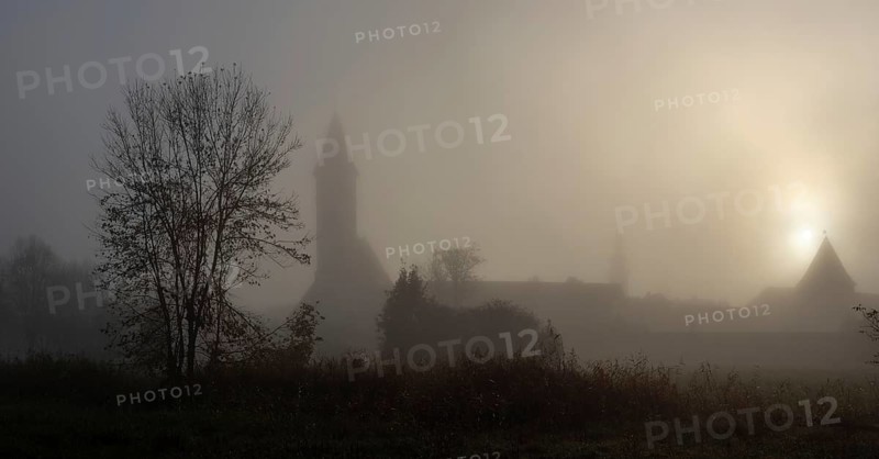 Church tower in the morning mist