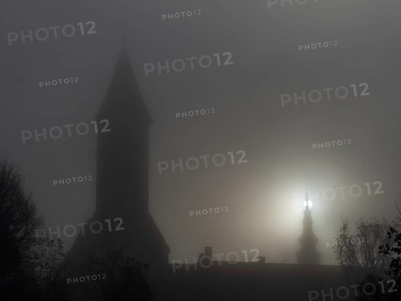 Church tower in the morning mist