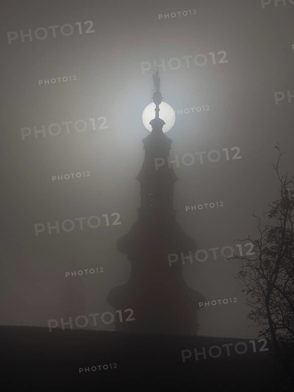 Church tower in the morning mist