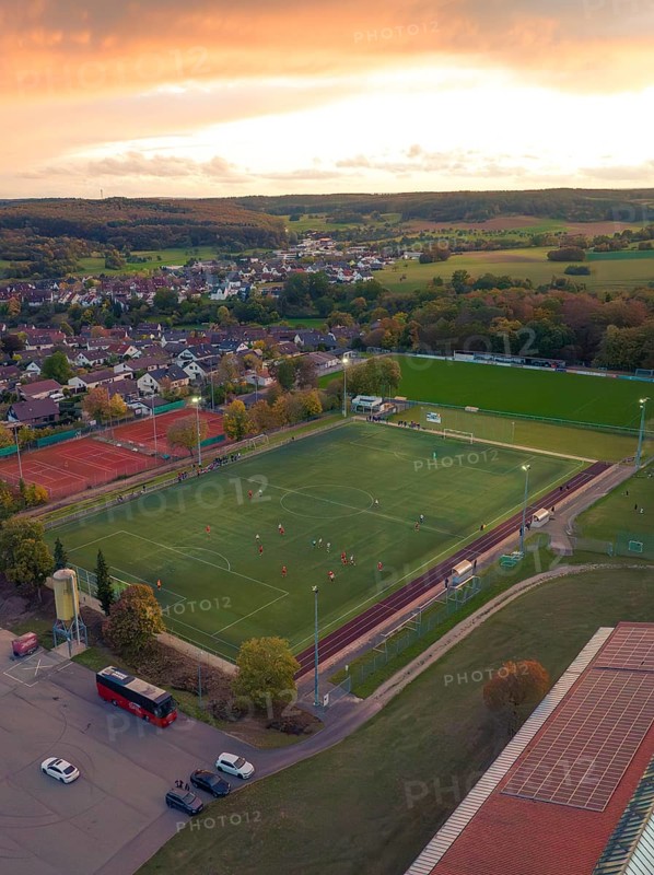 Football pitch in small village at sunset