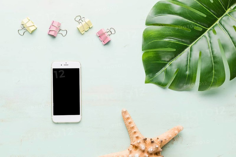 Beach holiday composition with phone light background