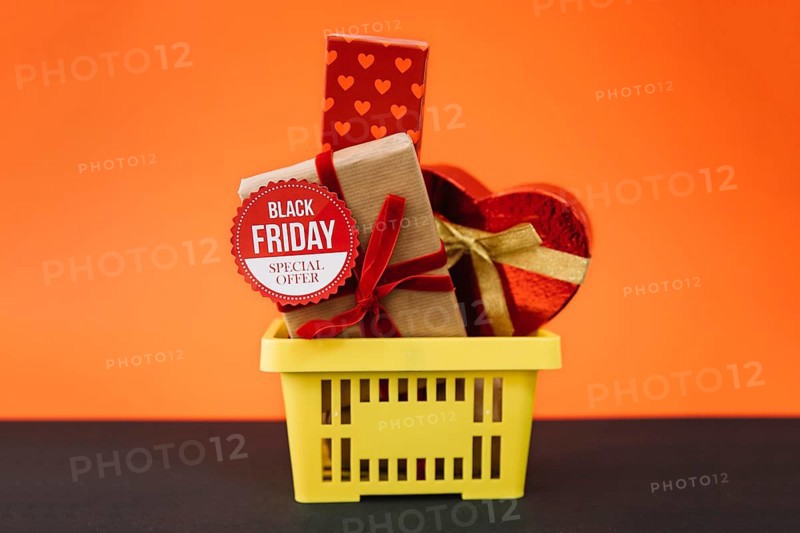 Black friday decoration with gifts shopping basket
