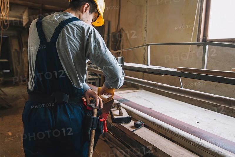 Carpentry concept with man working wood
