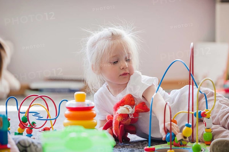 Charming kid with educational toys