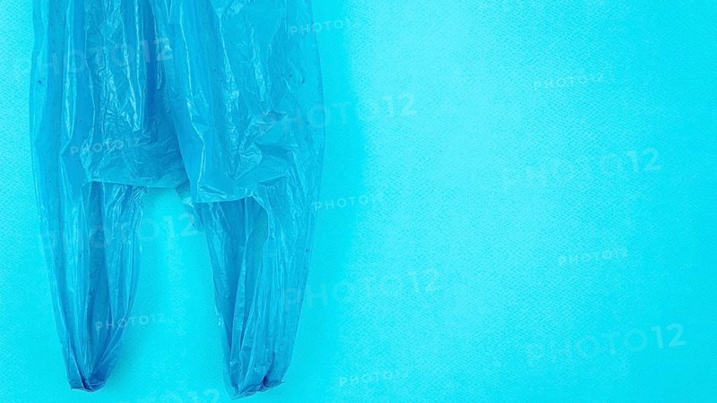 Clear disposable plastic bag blue background
