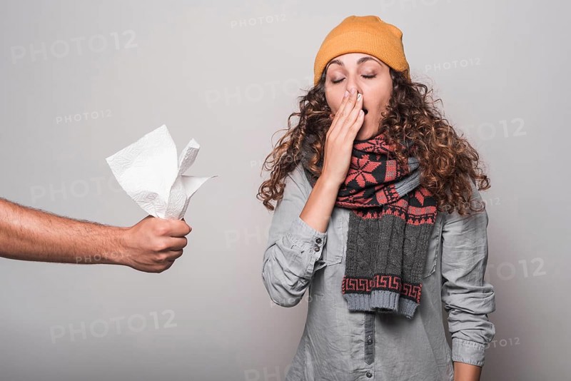 Close up hand giving tissue paper sick woman suffering from cold flu