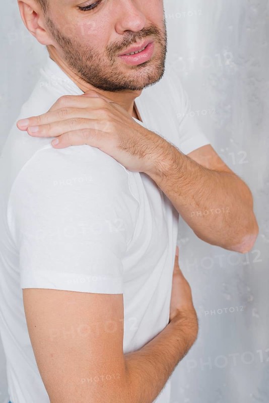 Close up man having pain his shoulder