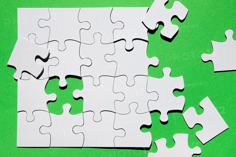 Close up puzzle piece green background