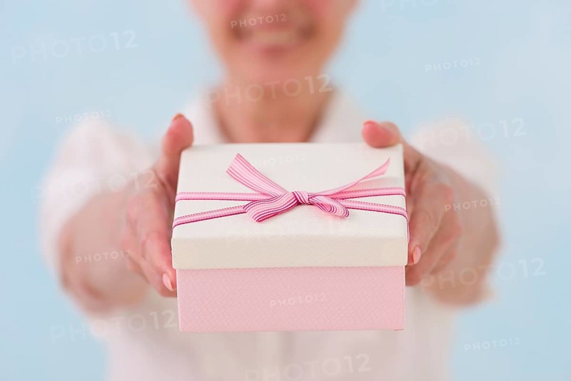 Close up woman s hand giving gift box