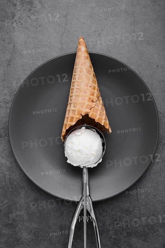 Cone with vanilla ice cream scoop