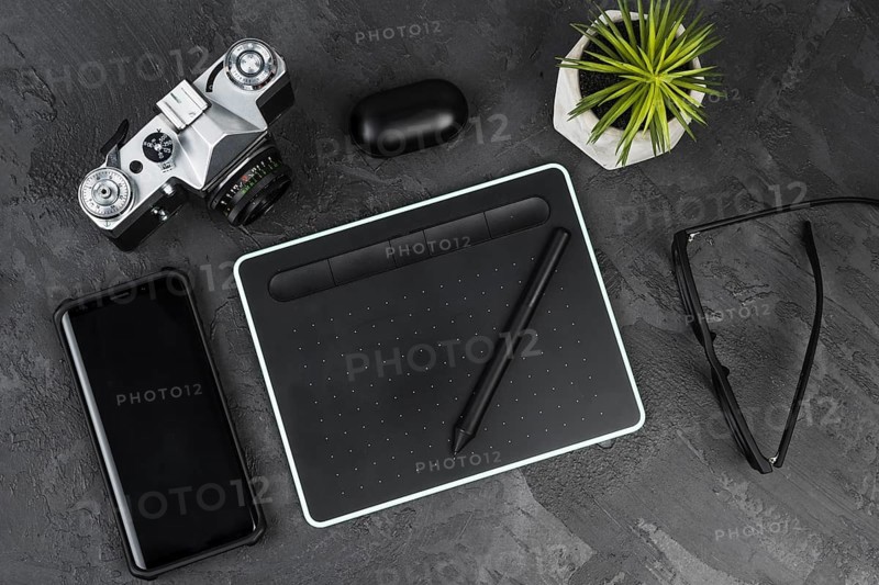 Desk arrangement slate background top view