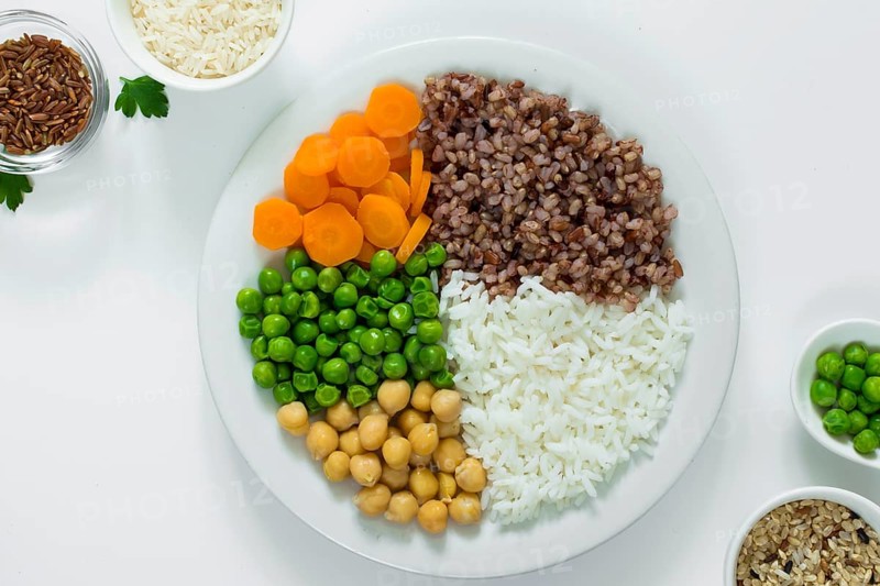 Different types porridge with vegetables plate with rice bowls table