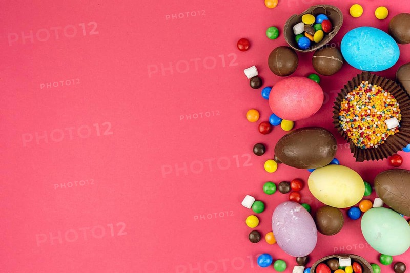 Easter eggs with chocolate eggs candies table