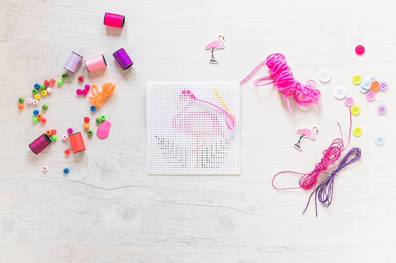 Embroidery cross stitch with floss thread decorative elements textured backdrop