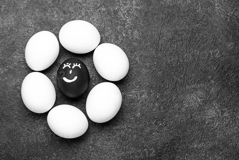 Flat lay different colored eggs with faces black lives matter movement copy space
