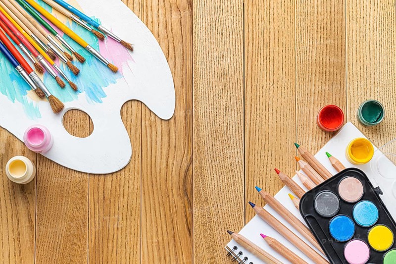 Flat lay painting essentials with brushes paint palette