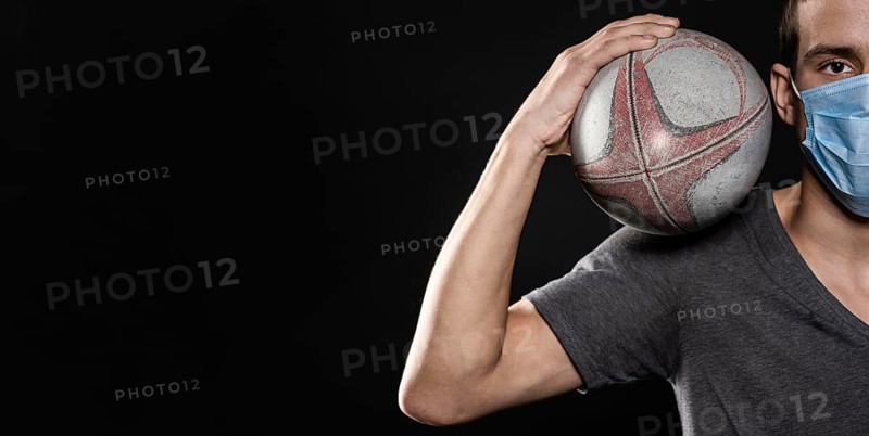 Front view male rugby player with medical mask ball