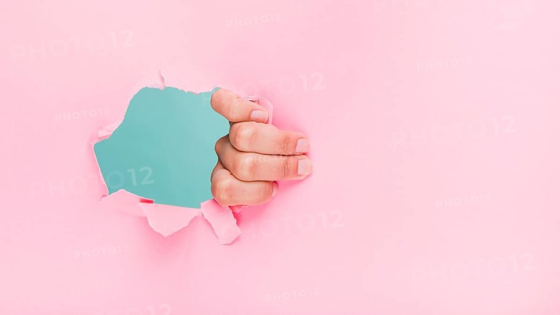 Hand through paper hole
