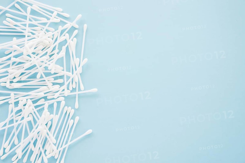 Heap cotton swabs blue background