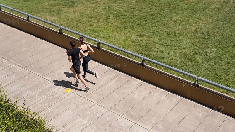 High angle man woman jogging together outside