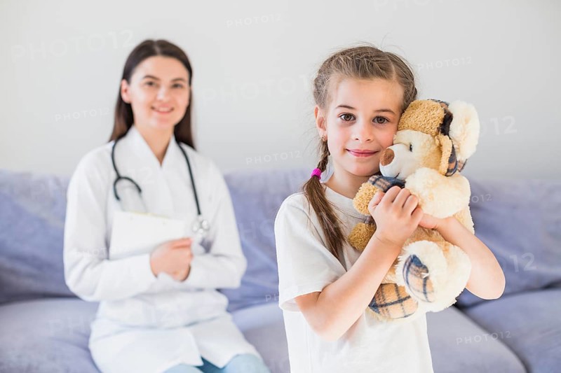 Ill girl being examined by doctor