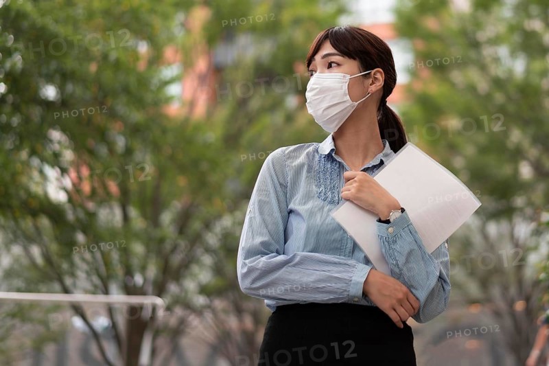 Low angle woman with face mask concept