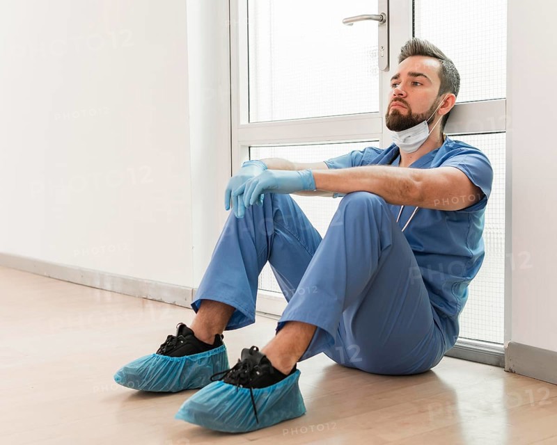 Male nurse tired after long day work