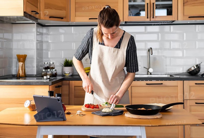 Medium shot woman cooking home