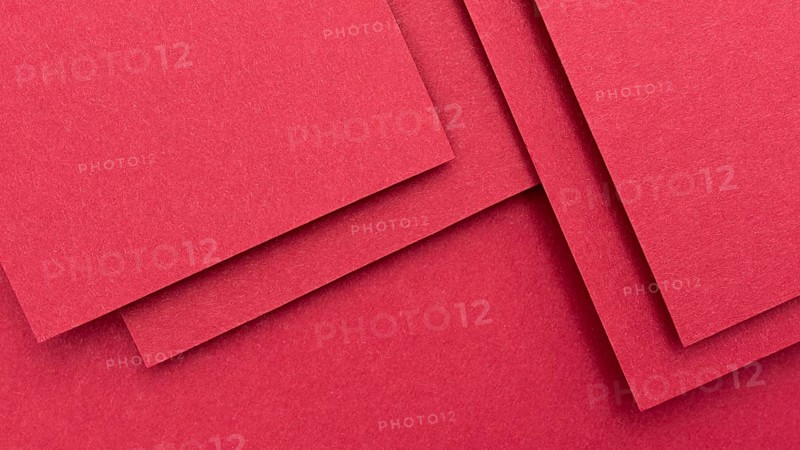 Monochromatic still life arrangement with red paper