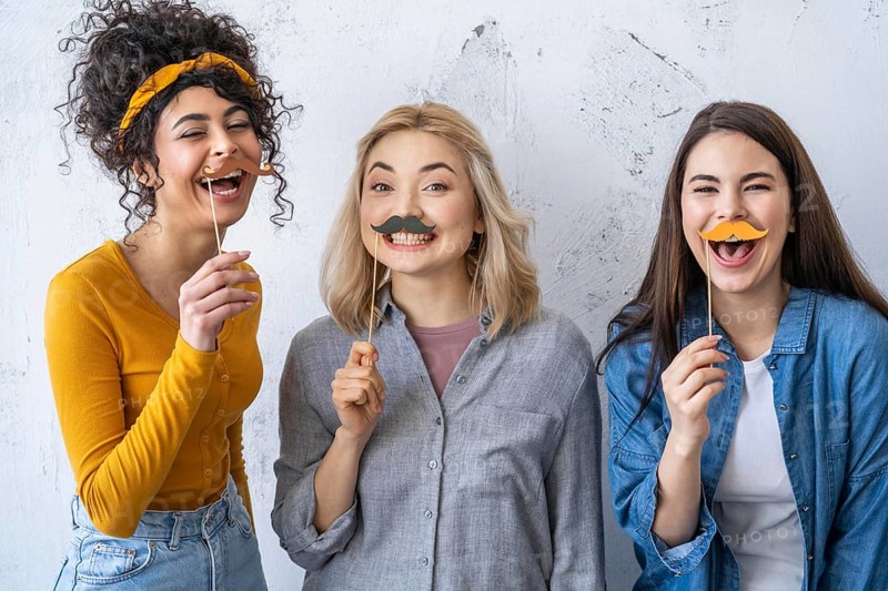 Portrait happy laughing women with mustaches