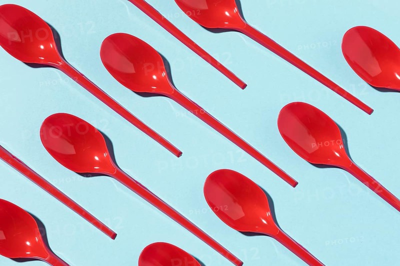 Red plastic spoons top view