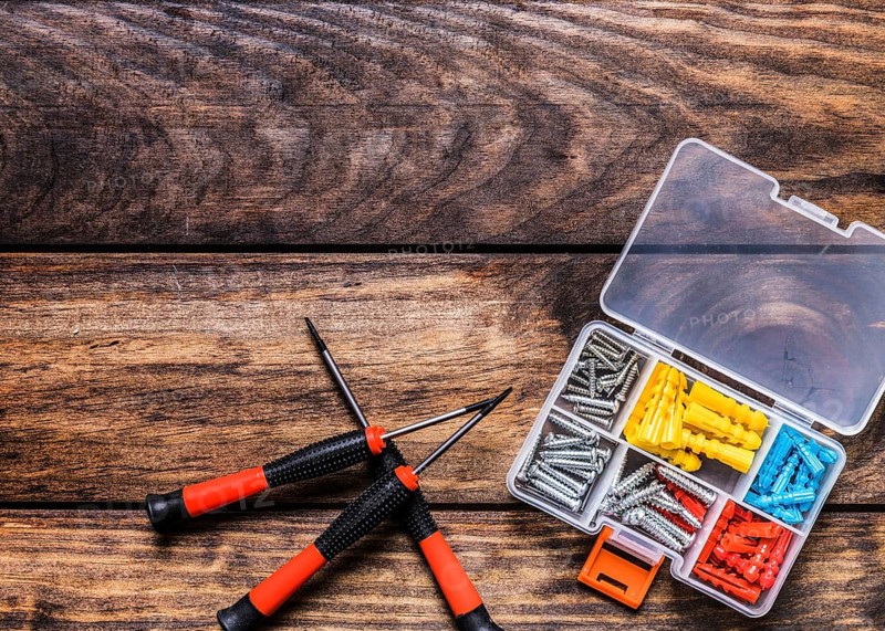 Screwdrivers with bolt kit wooden background
