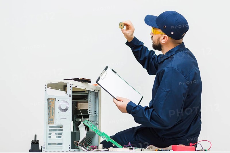 Sideways man repairing computer