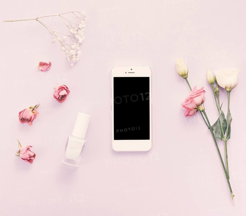 Smartphone with roses nail polish table