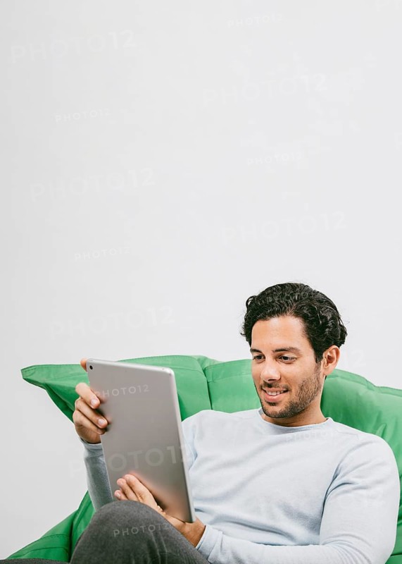 Smiley man having fun with tablet