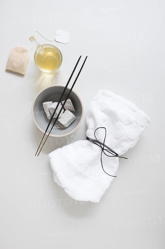 Teabag oil pumice stone incense stick tied napkin white surface