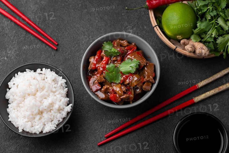 Top view asian dish with rice chopsticks