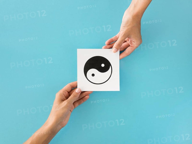 Top view hands exchanging ying yang symbol