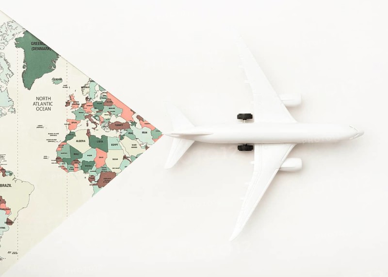 Travel concept with world map toy plane