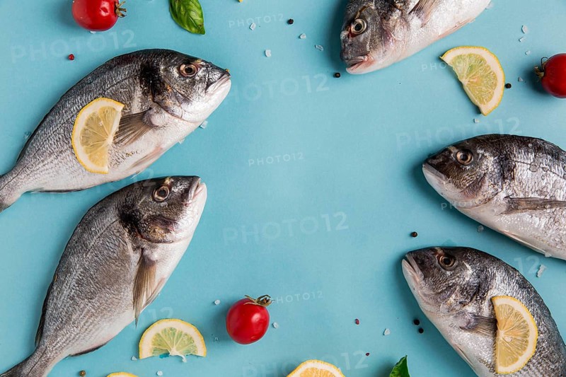 Uncooked seafood fish with lemon tomatoes