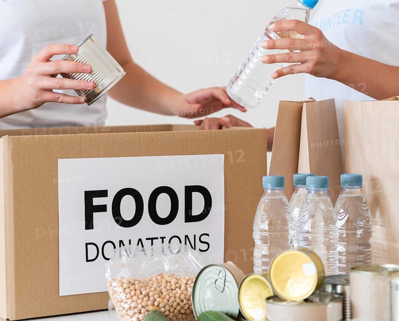 Volunteers with box water bottles donation