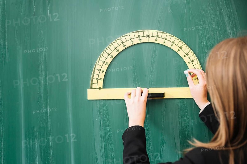 Woman drawing geometrical figure blackboard
