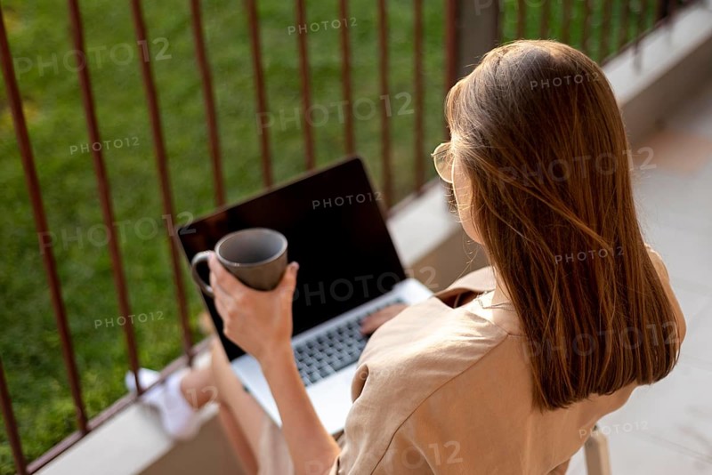 Woman home quarantine working with laptop outdoors