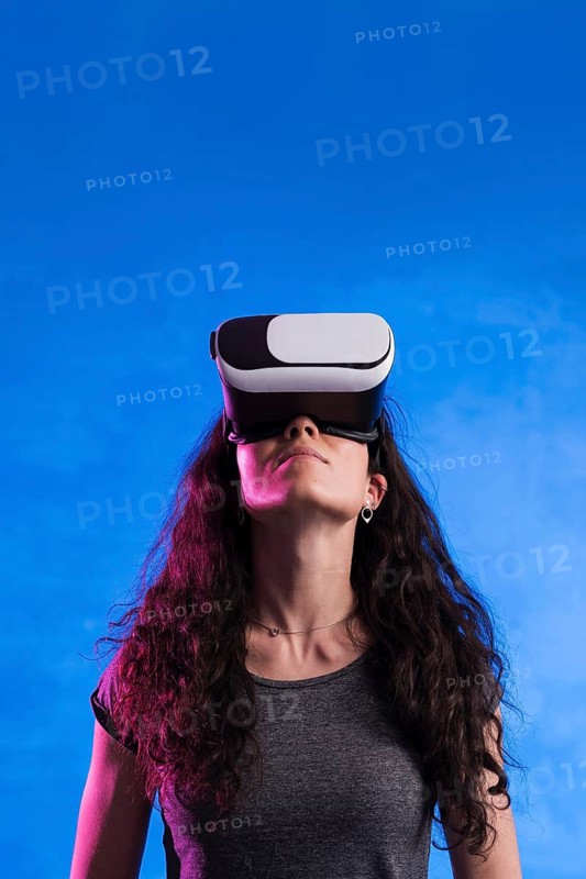 Woman using virtual reality headset outdoors