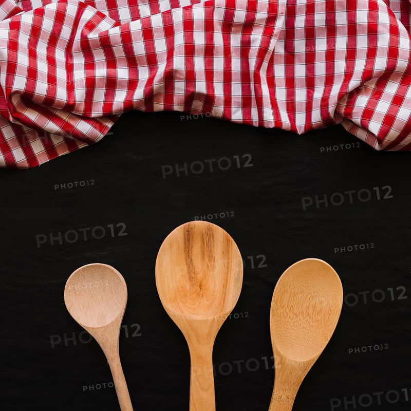 Wooden spoons near napkin