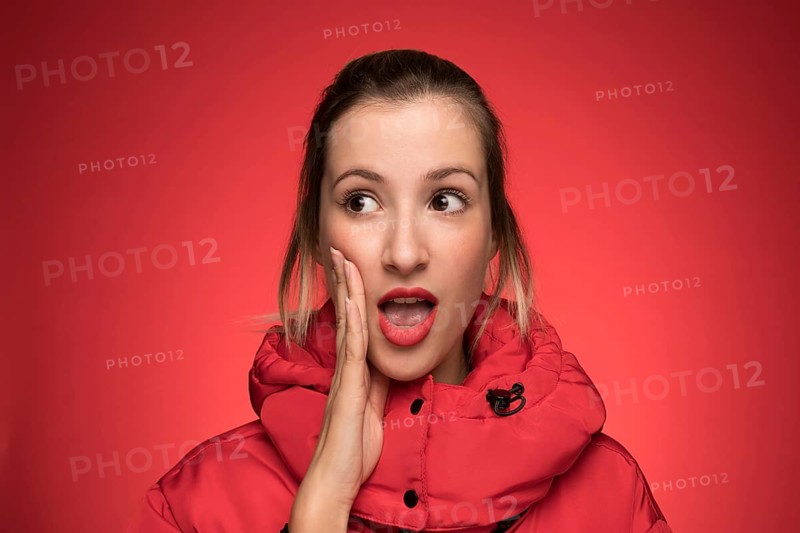 Young woman red winter coat shouting sign