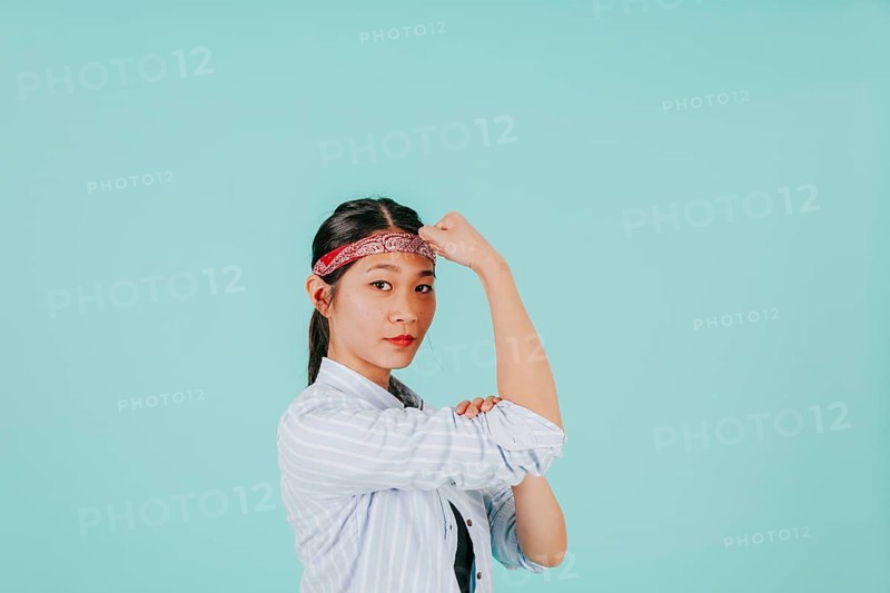 Asian woman showing biceps