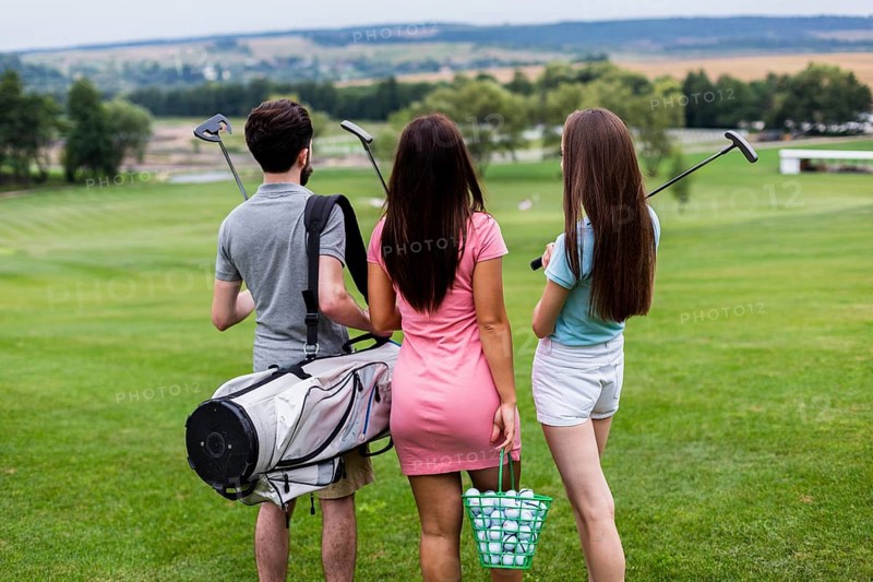 Back view friends with golf equipment
